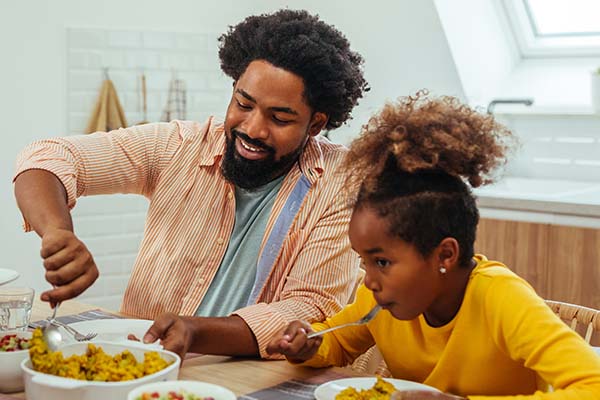 Child and adult eating together