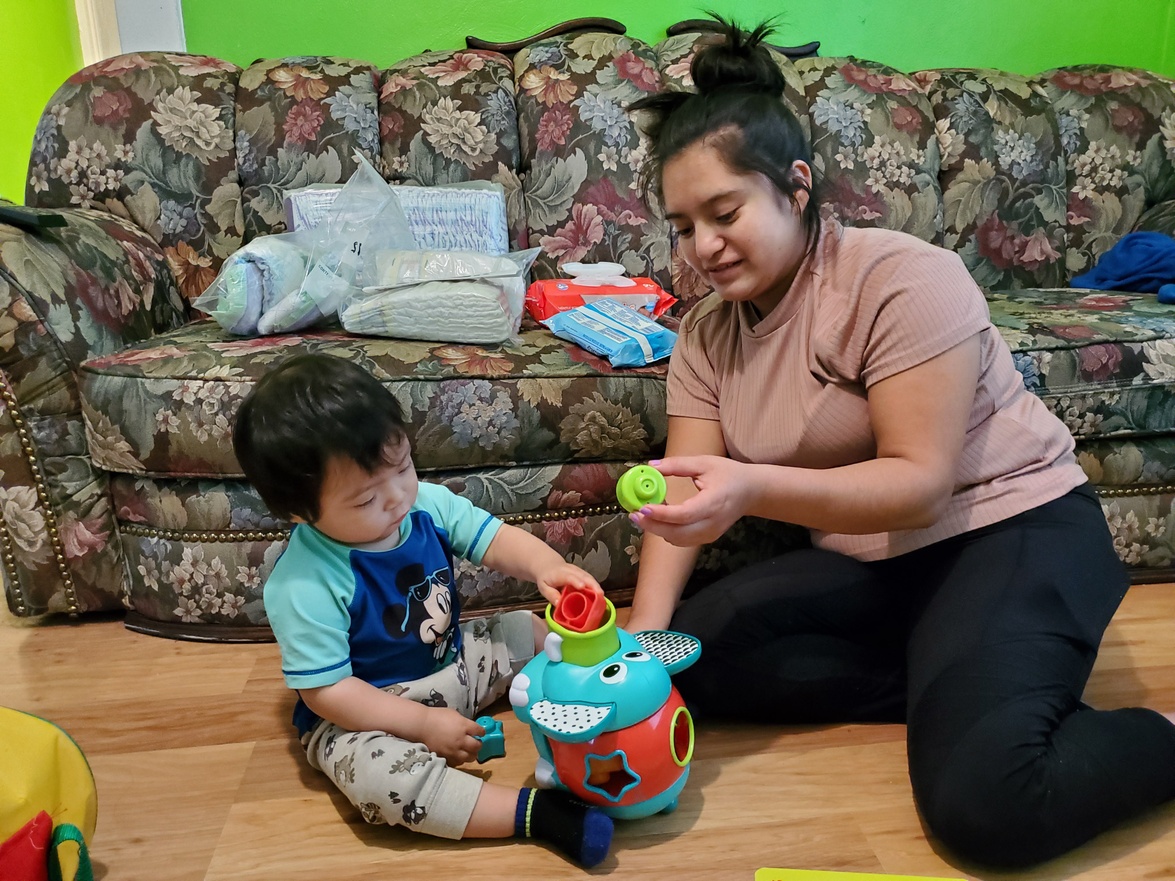 A toddler playing with enriching toys