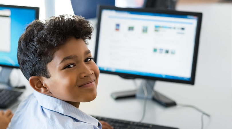 Elementary school age boy using a computer for e-learning