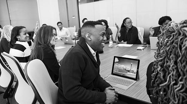 Group of people smiling around a table