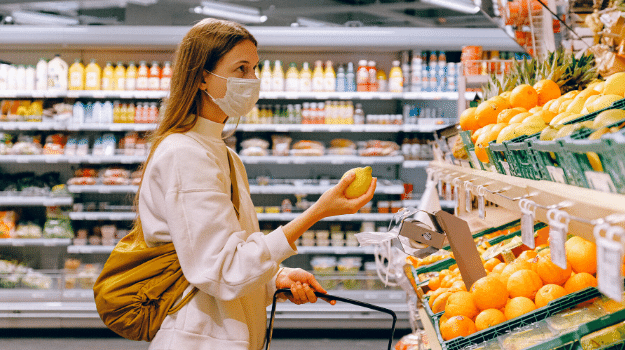 Woman wearing surgical mask in a grocery store