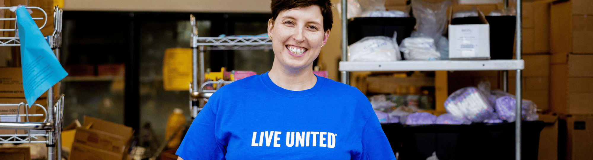 Person wearing blue LIVE UNITED tee shirt