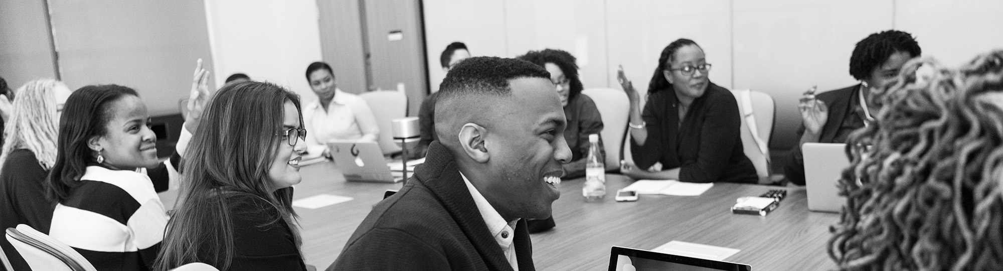 Group of people smiling around a table