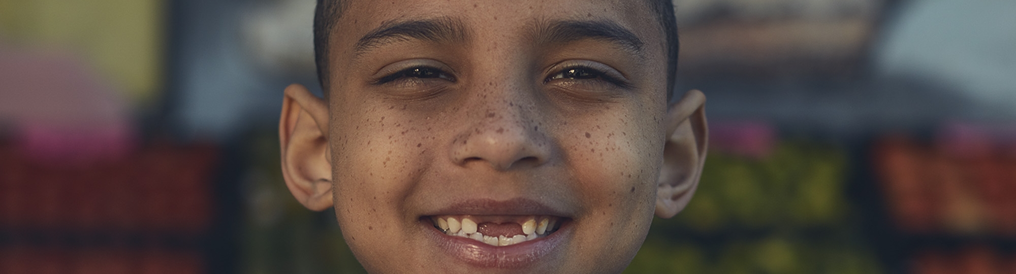 Boy with missing front teeth smiling