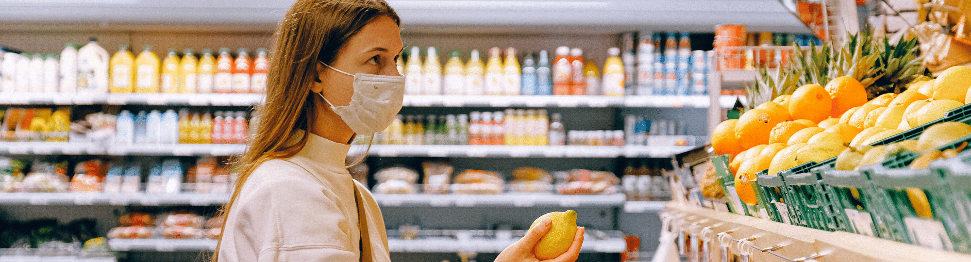 Woman wearing surgical mask in a grocery store