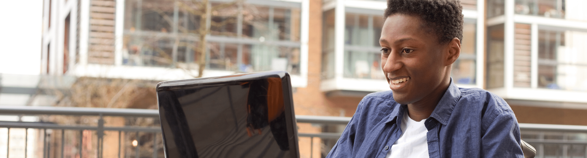 Young man in wheelchair using computer