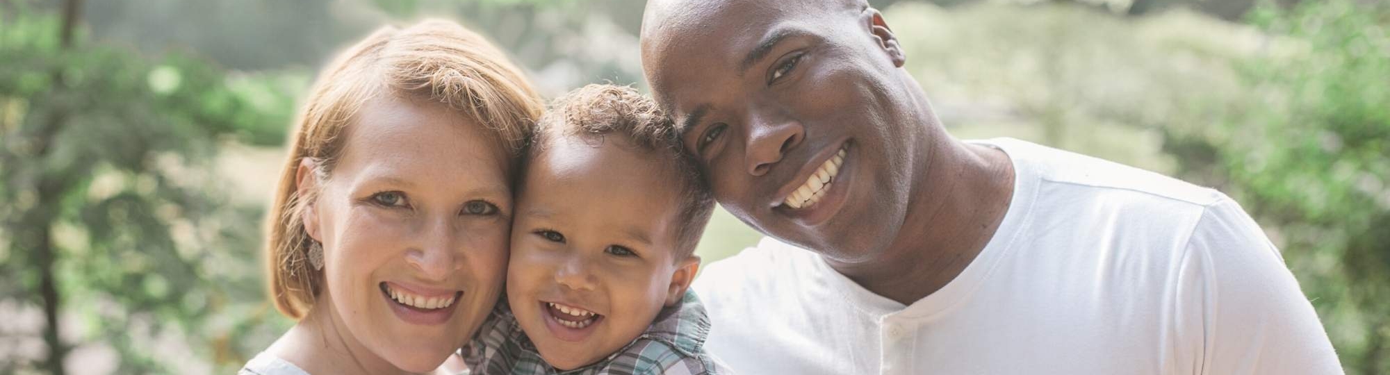 Mother, father and toddler smiling