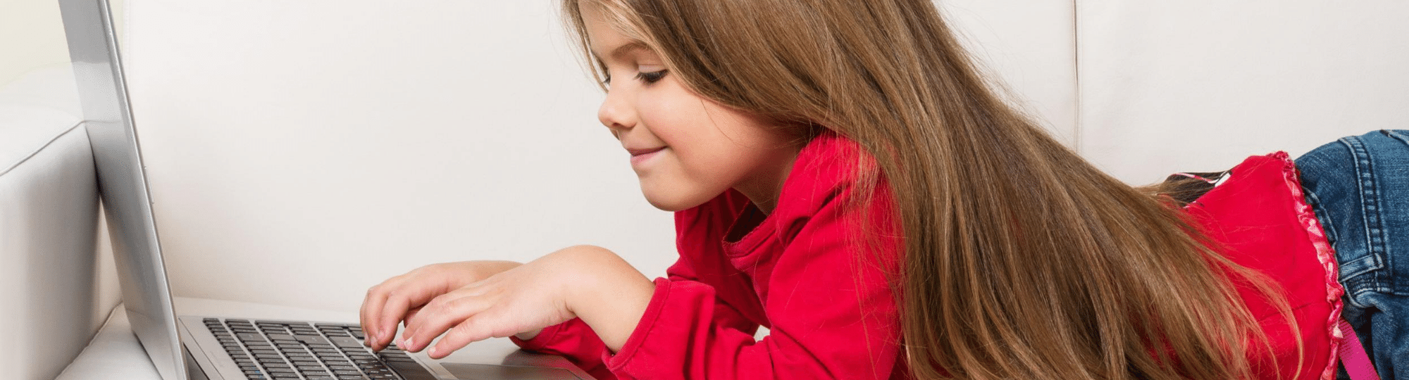 Elementary school age girl using a computer for e-learning