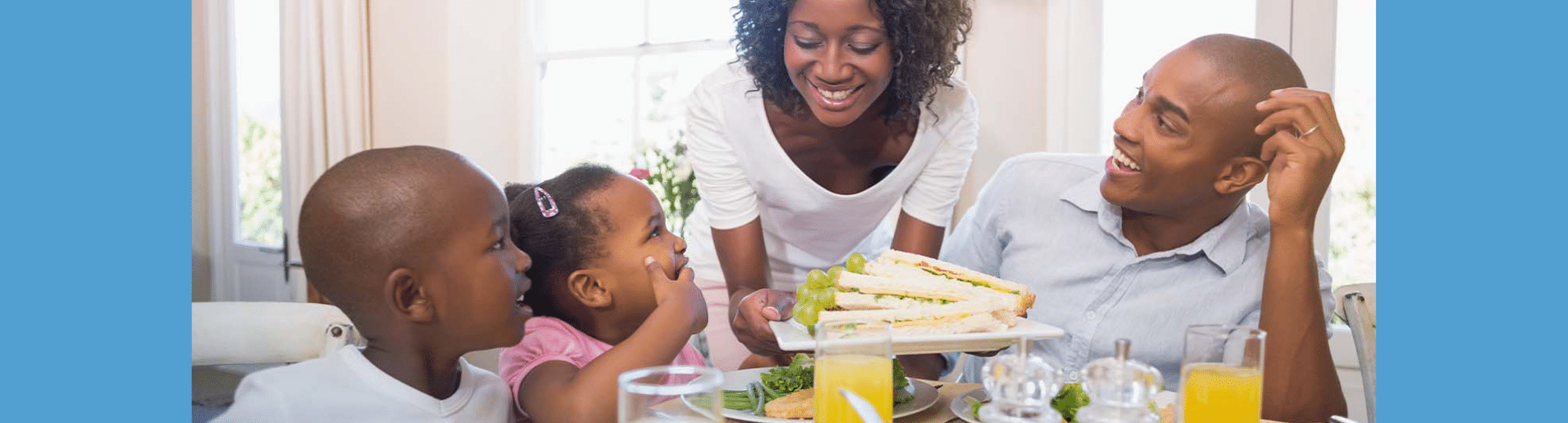 Family smiling with food