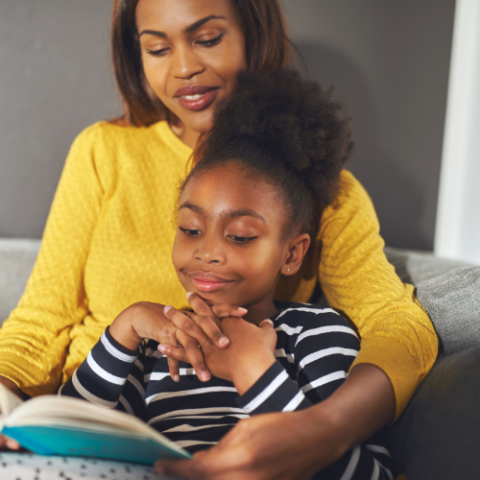 mother and daughter reading a book