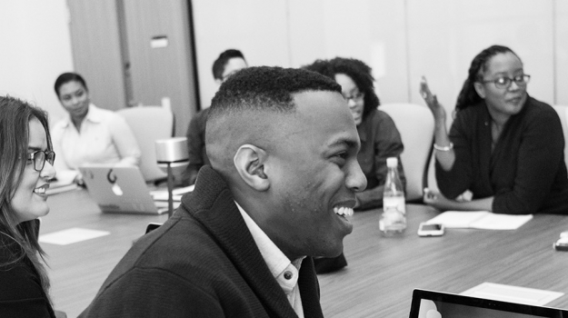 Group of people smiling around a table