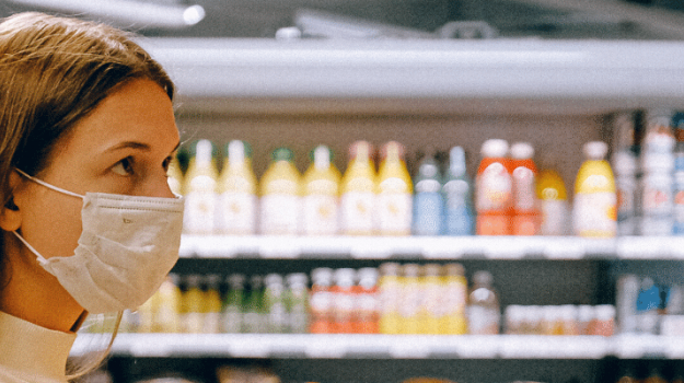 Woman wearing surgical mask in a grocery store
