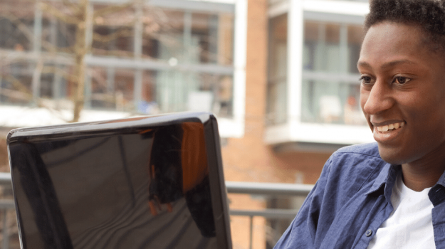 Young man in wheelchair using computer