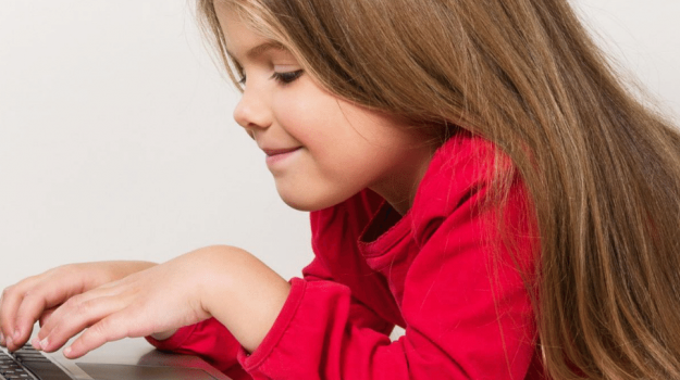 Elementary school age girl using a computer for e-learning