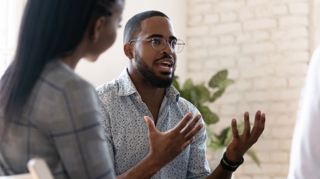 Black man talking to small group