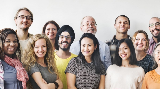 One dozen smiling people of many races and ethnicities