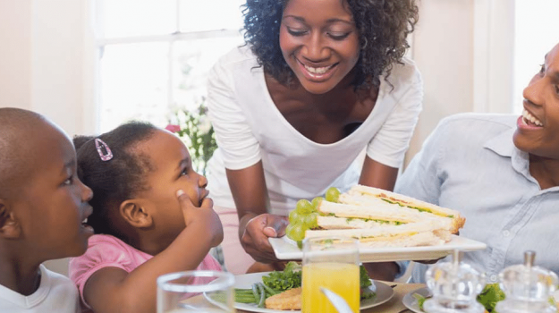 Family smiling with food