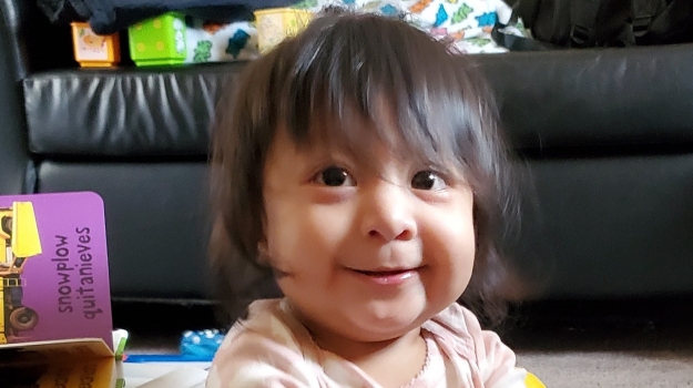 A toddler playing with enriching toys